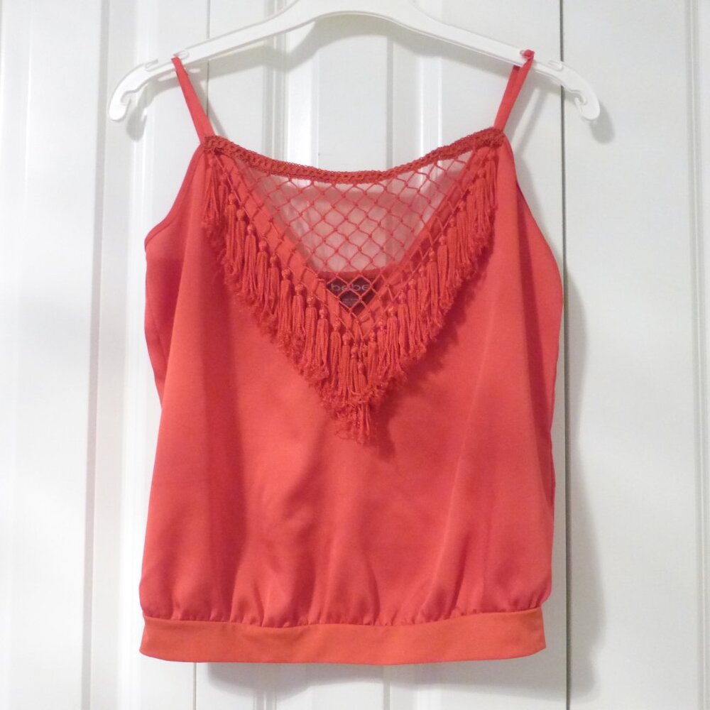 BEBE bright orange satin top with tassels and bubble hem